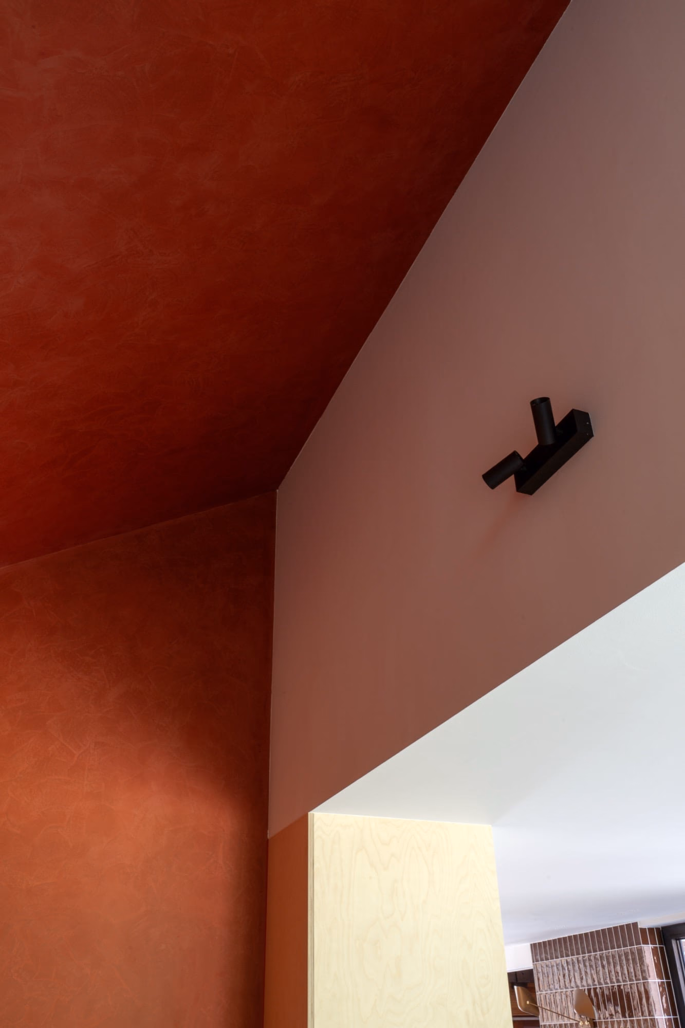 A red and white wall with a black object