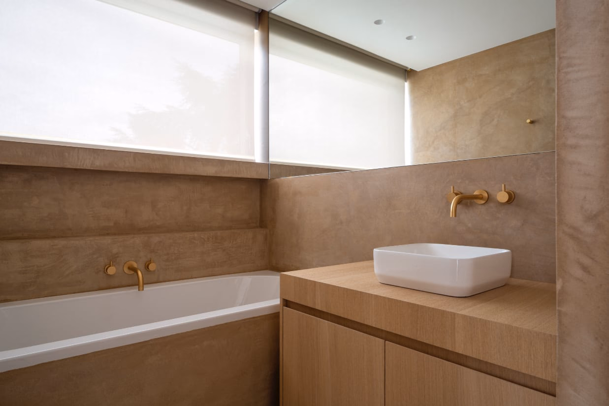 A bathroom with a washbasin and a window