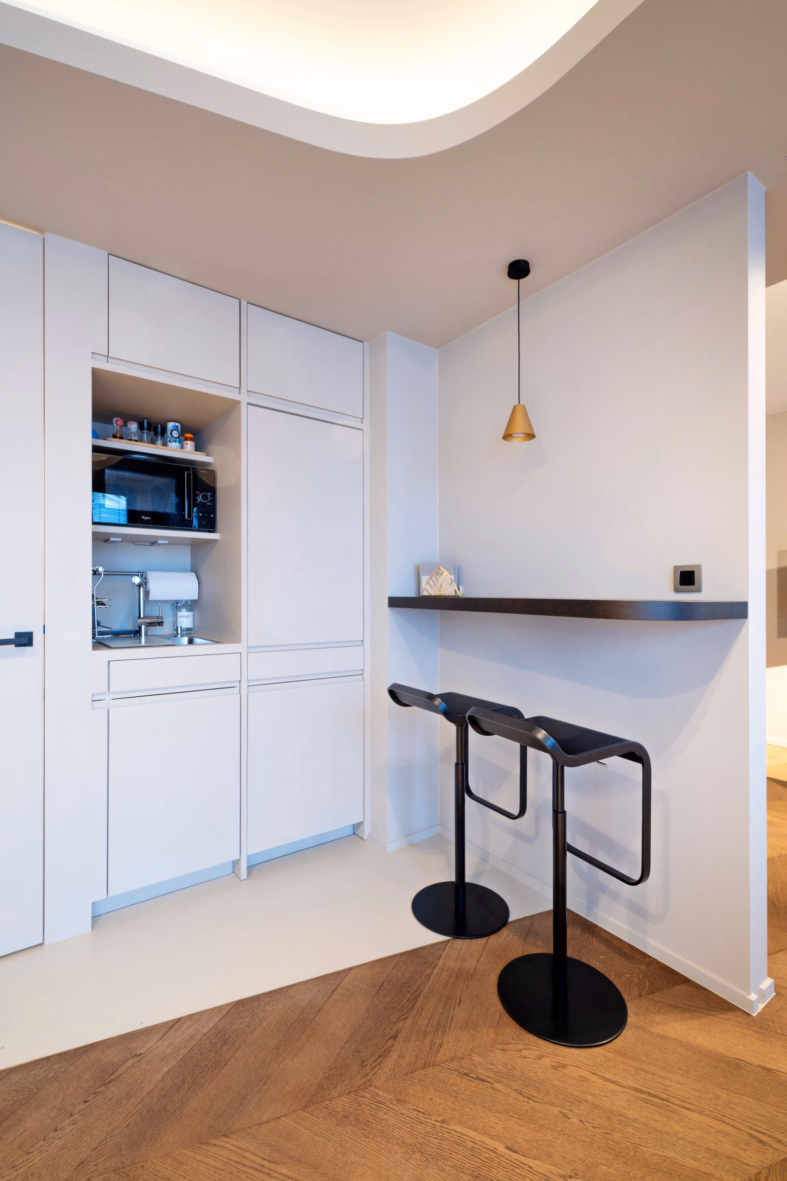 A small kitchen with a microwave and a sink