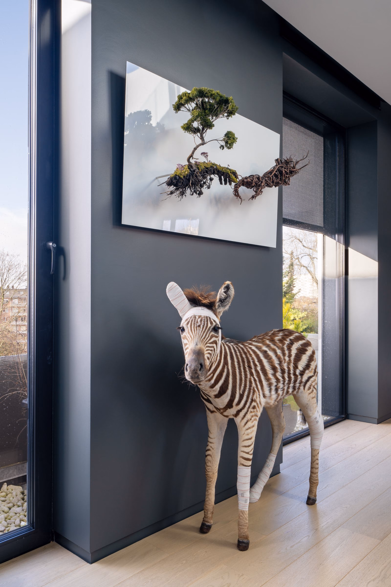 A zebra sculpture in front of a window