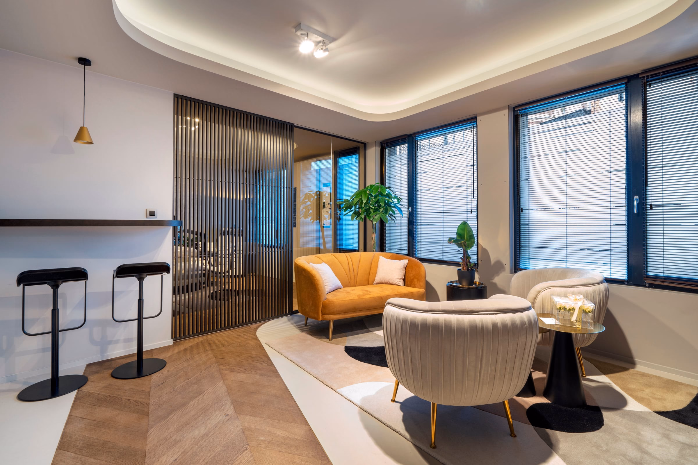 A living room with a sofa and two armchairs
