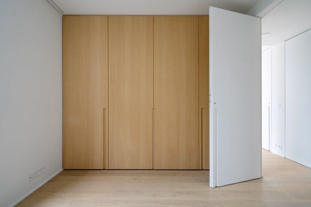 A room with wooden cabinets and a white door