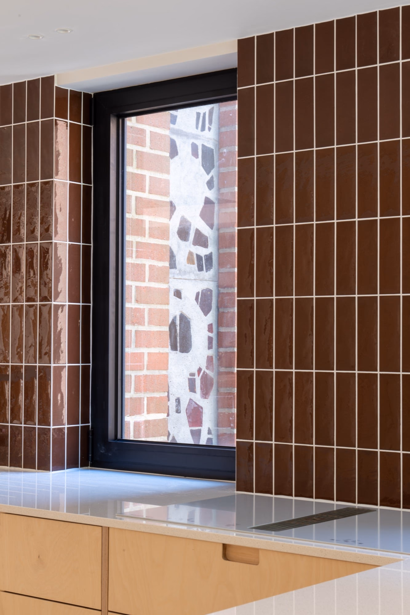 A window with a brick wall beyond