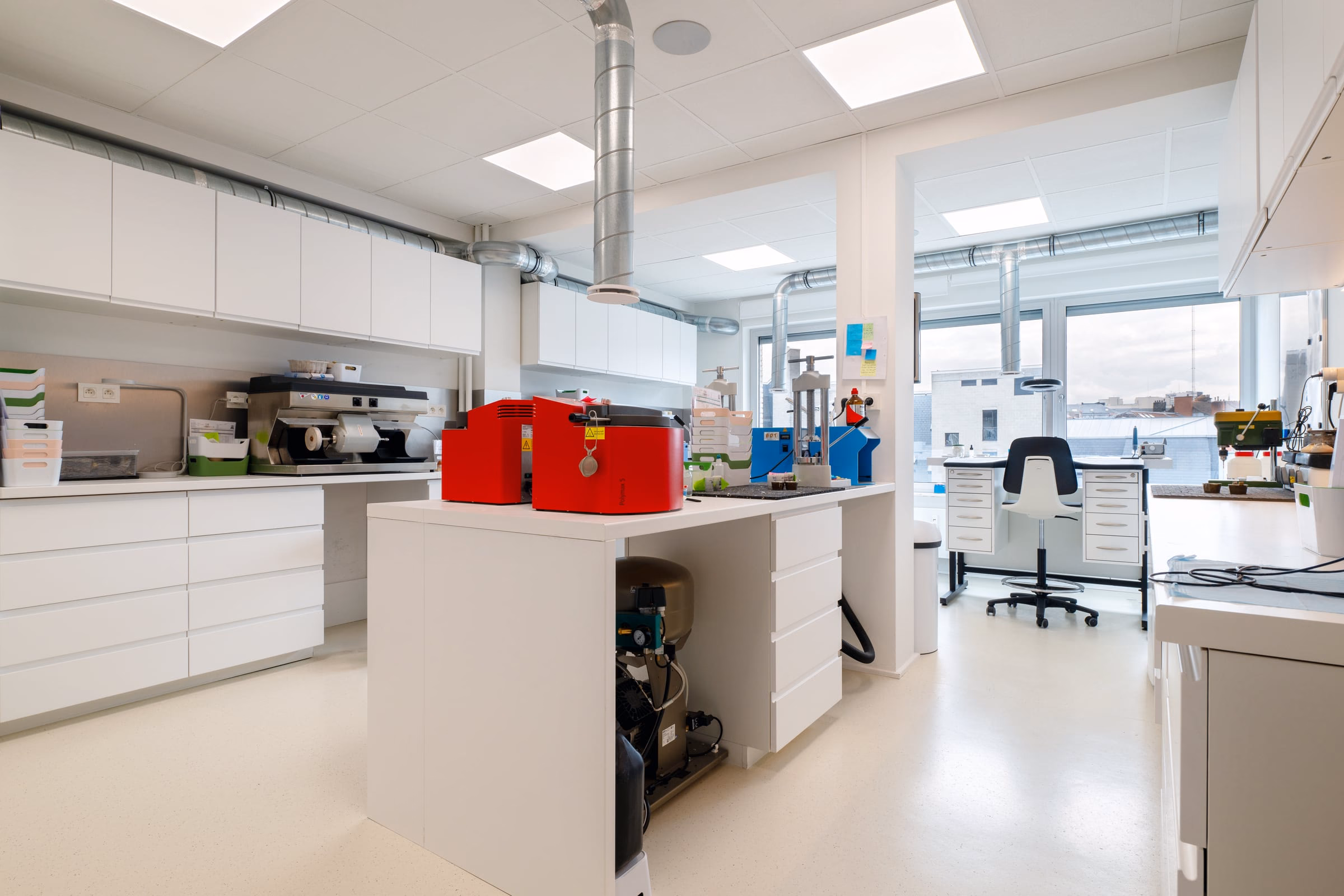 A red machine on a laboratory counter