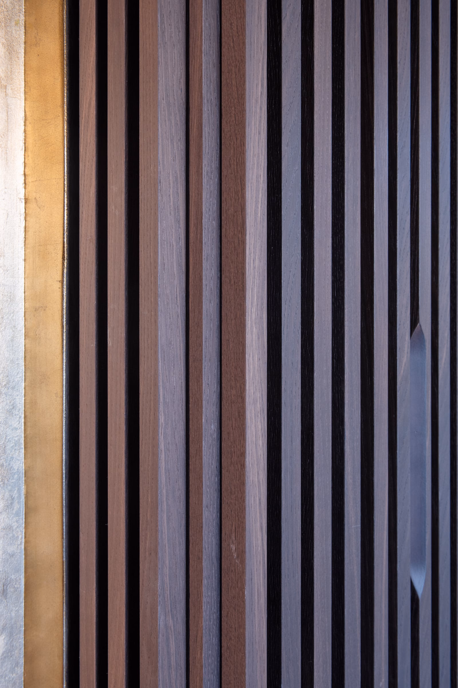 Detail of a wooden wall with gold trim