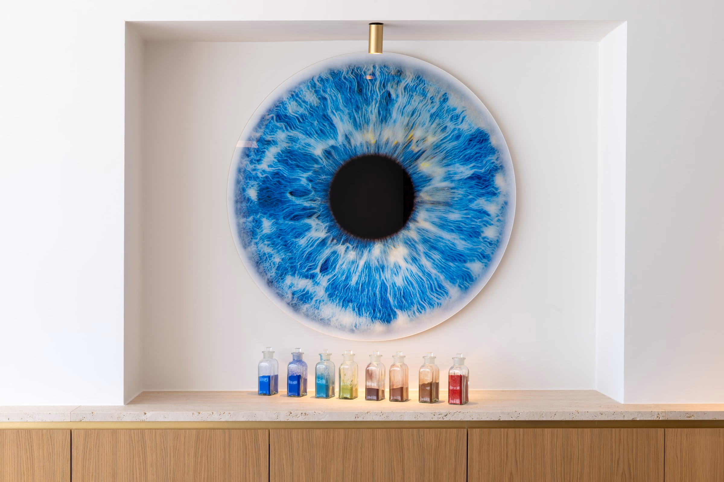 A painting of a blue eye on a wall