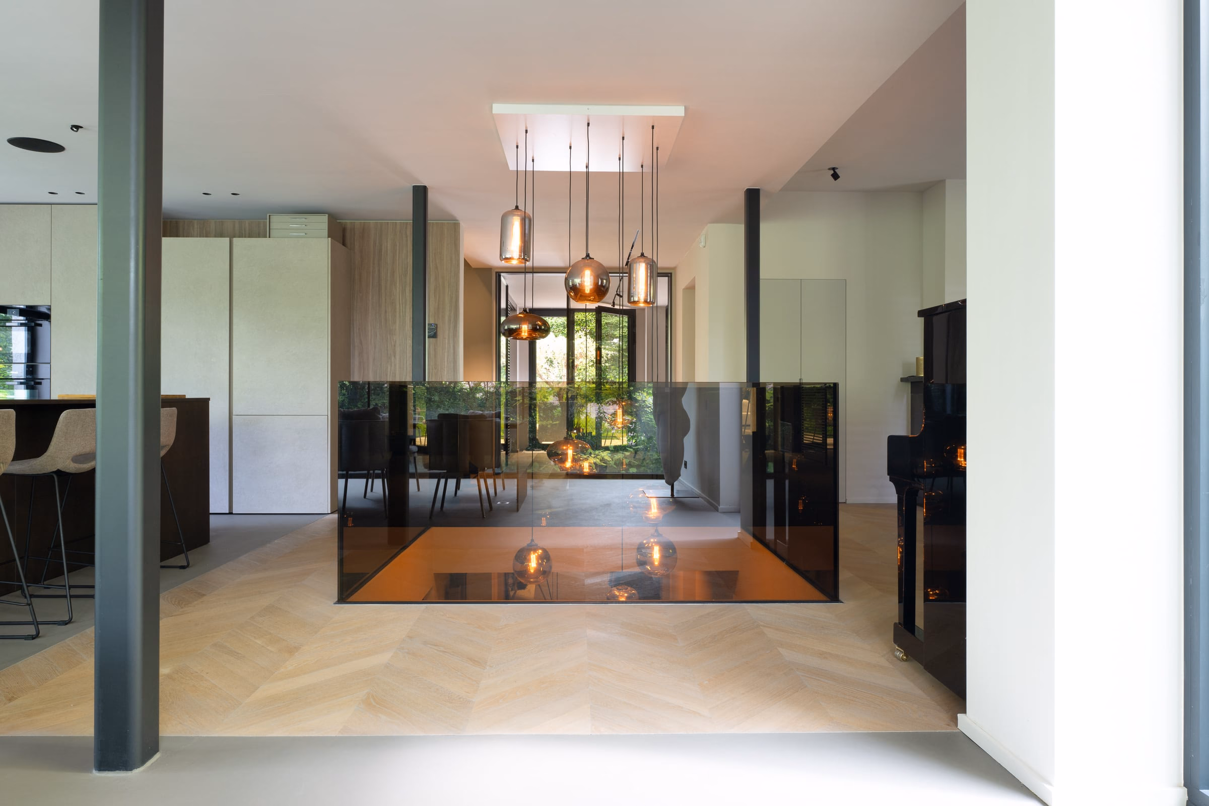 A dining room with a piano beyond