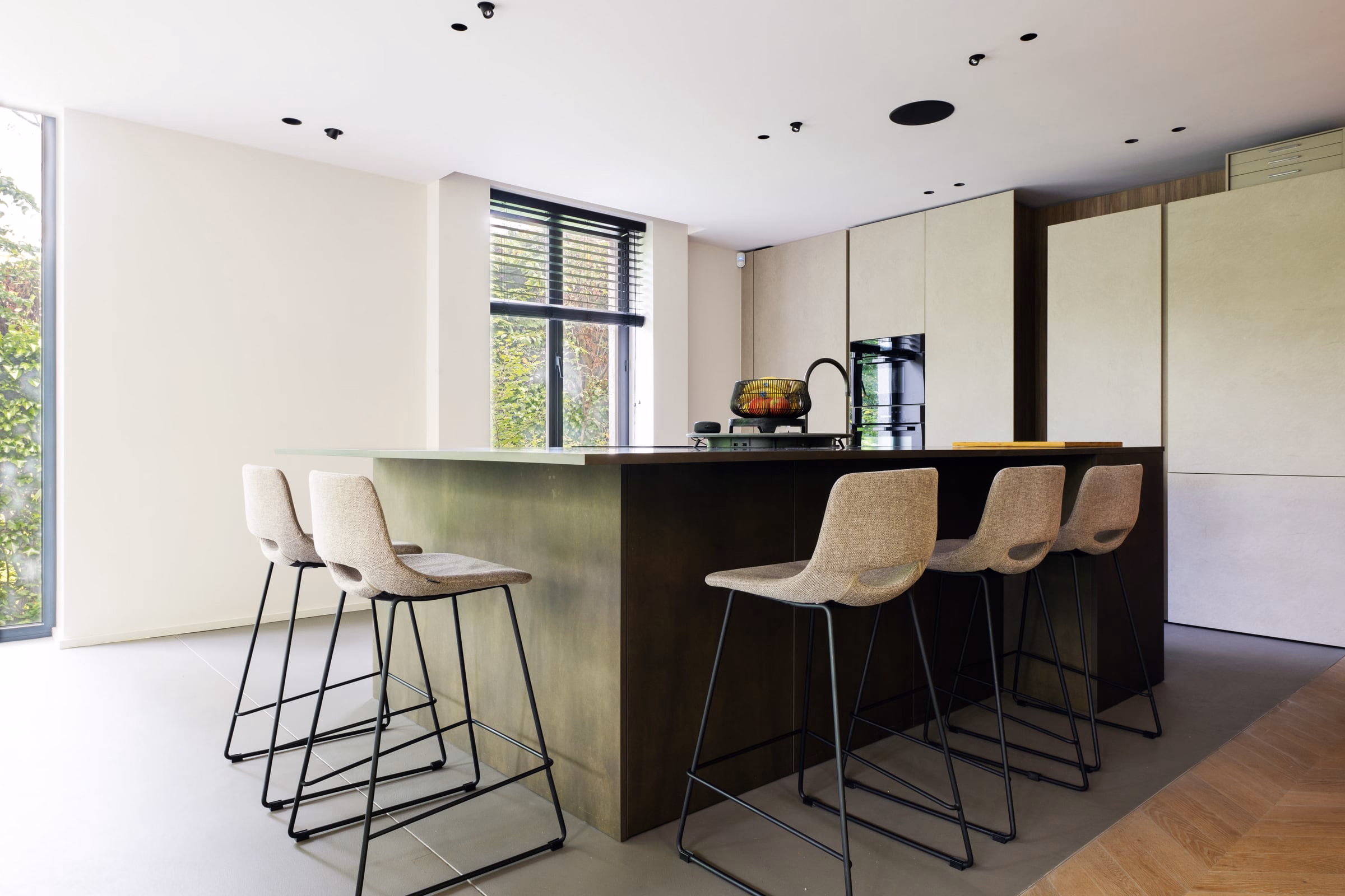 A kitchen with a large island and stools