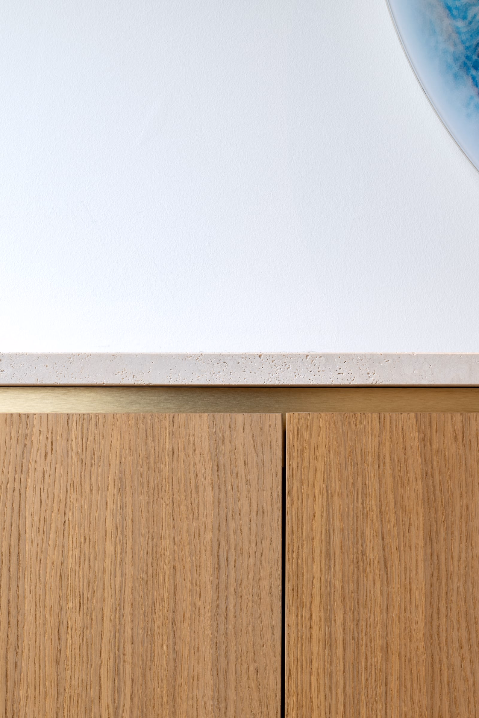 A white worktop with wooden cabinets beneath