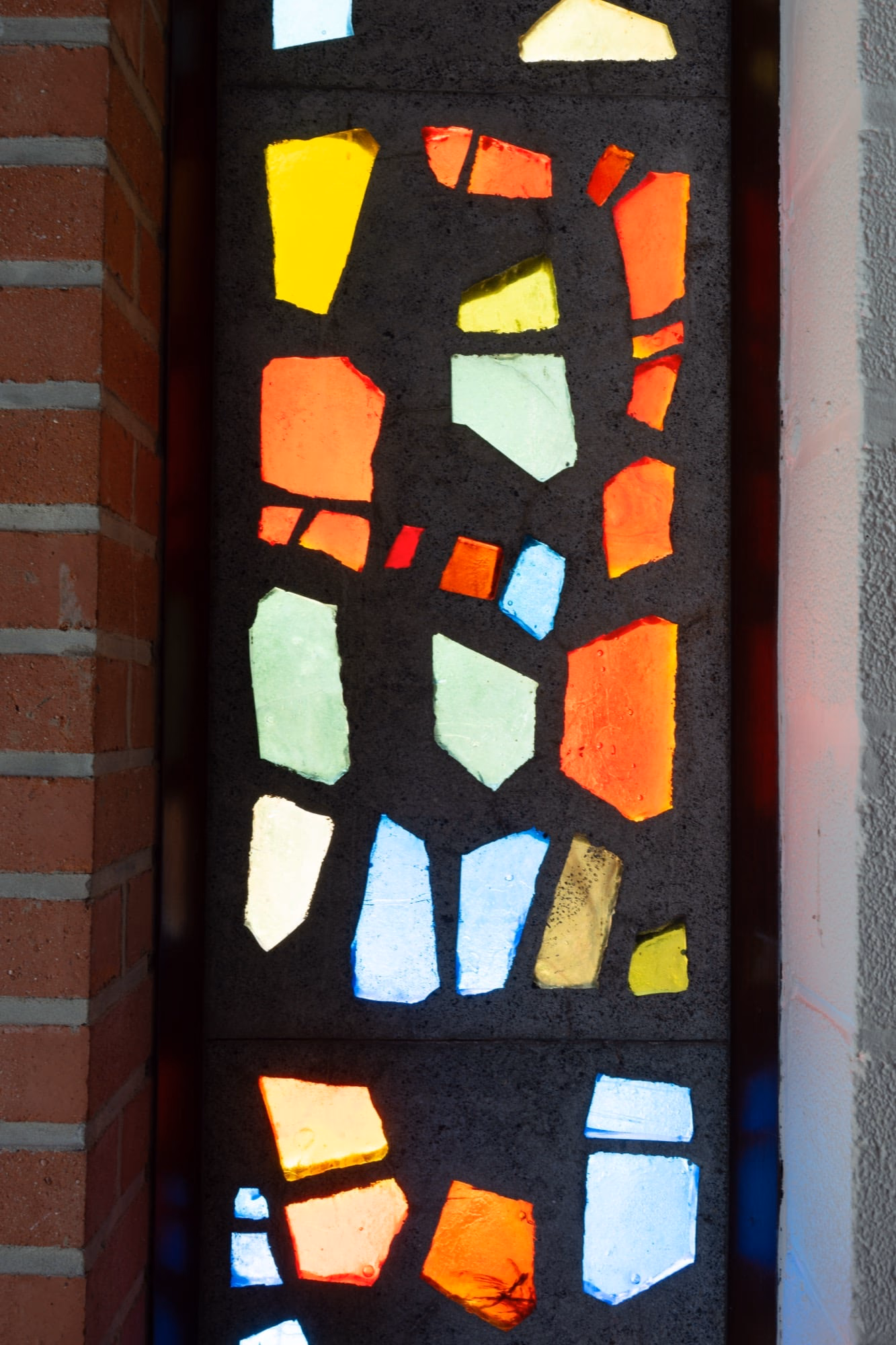 A brick wall with a stained-glass window