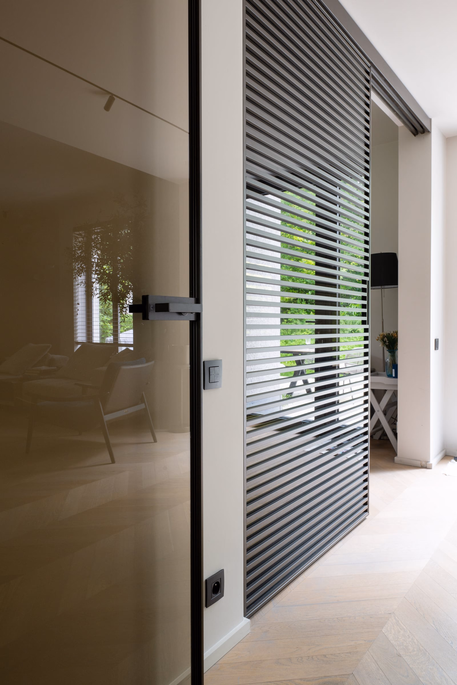 A sliding glass door with a black handle
