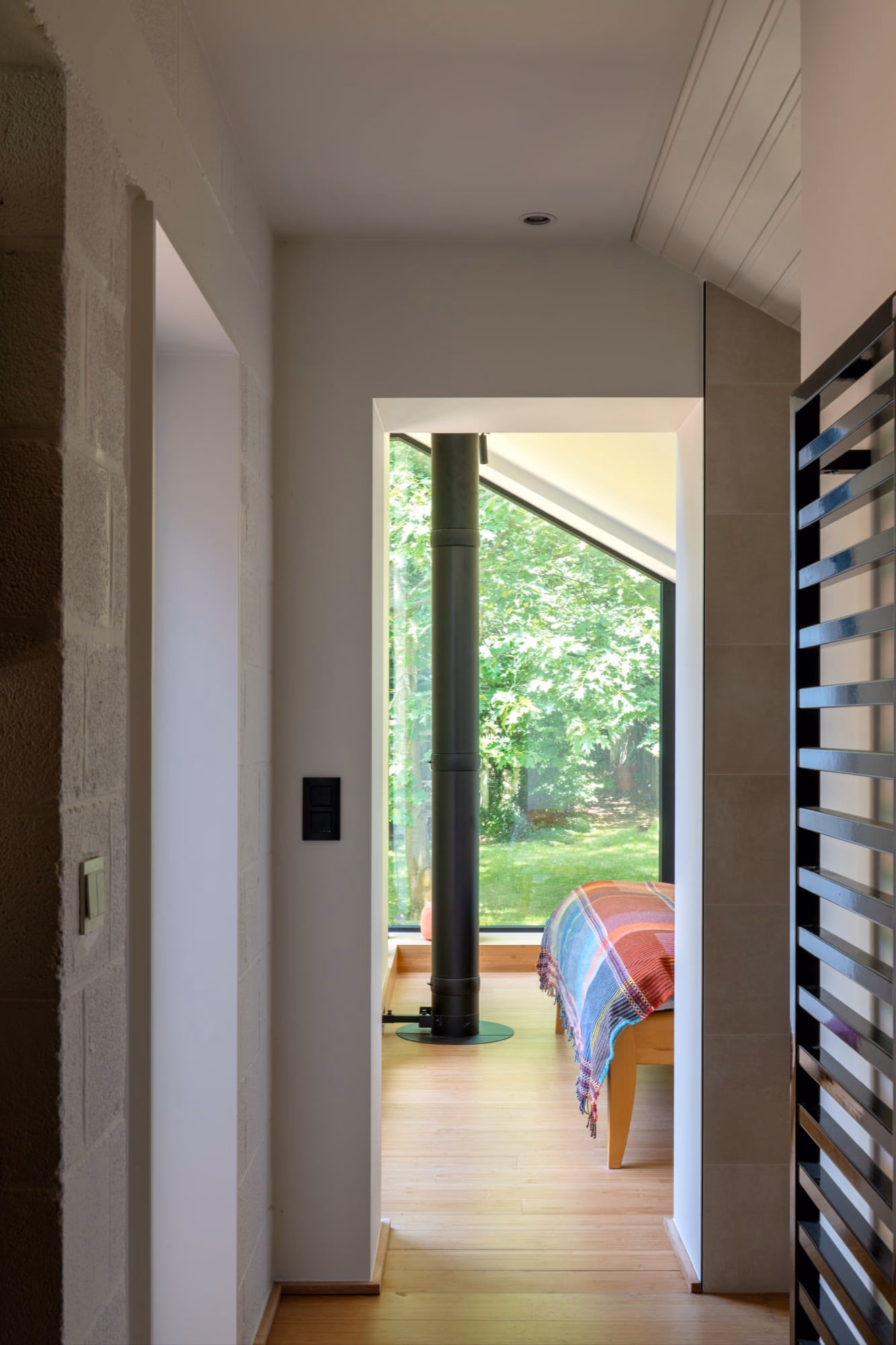 A bedroom with a bed and a large window