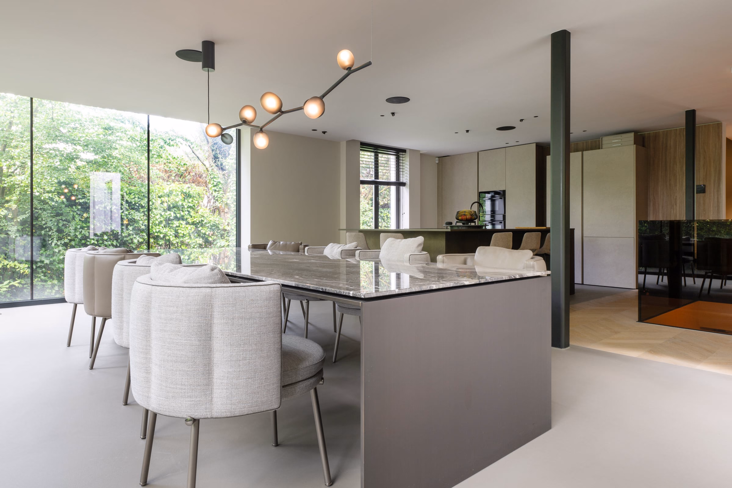 A dining room with a marble table and chairs