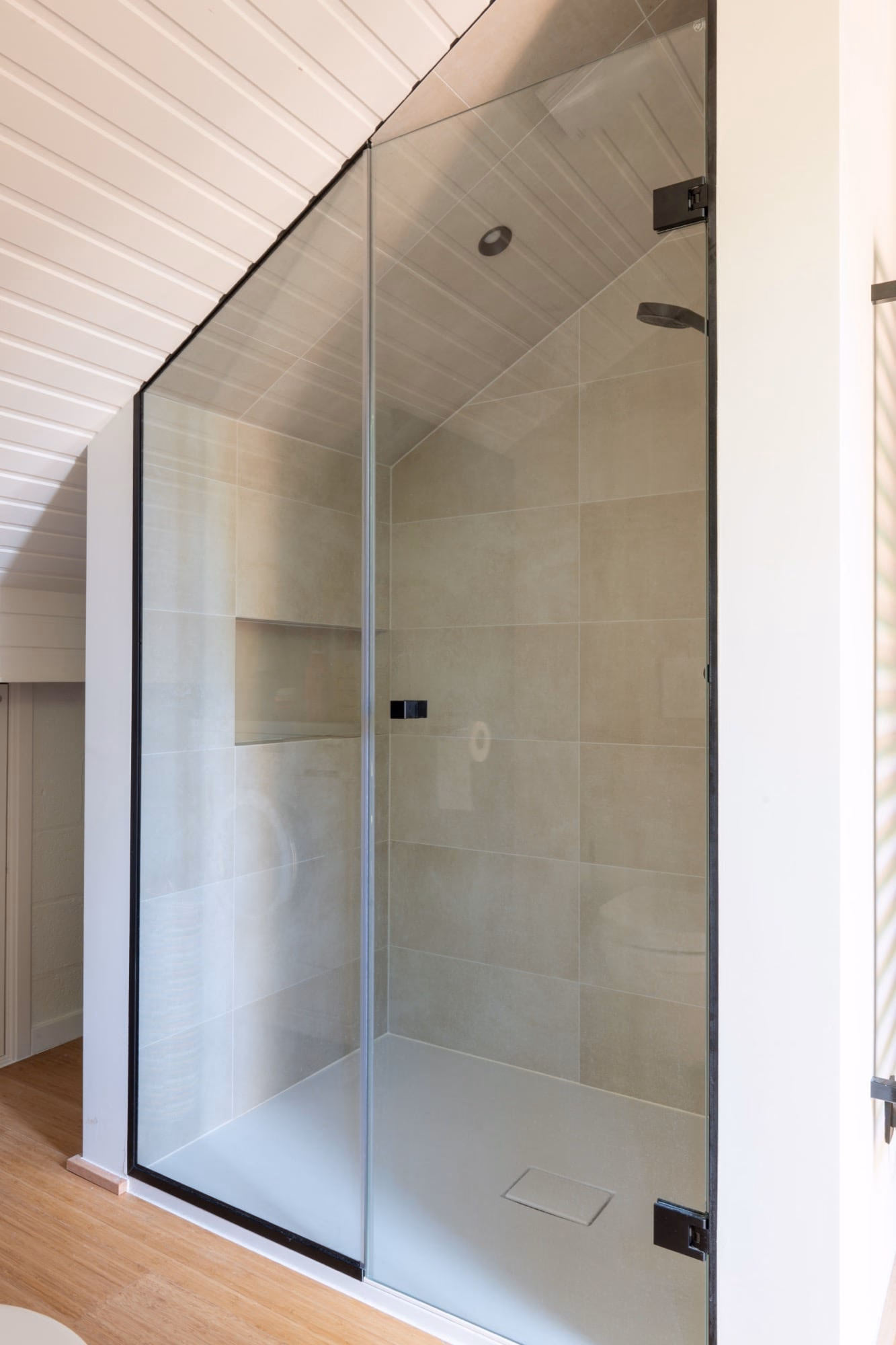 A bathroom with a glass-doored shower