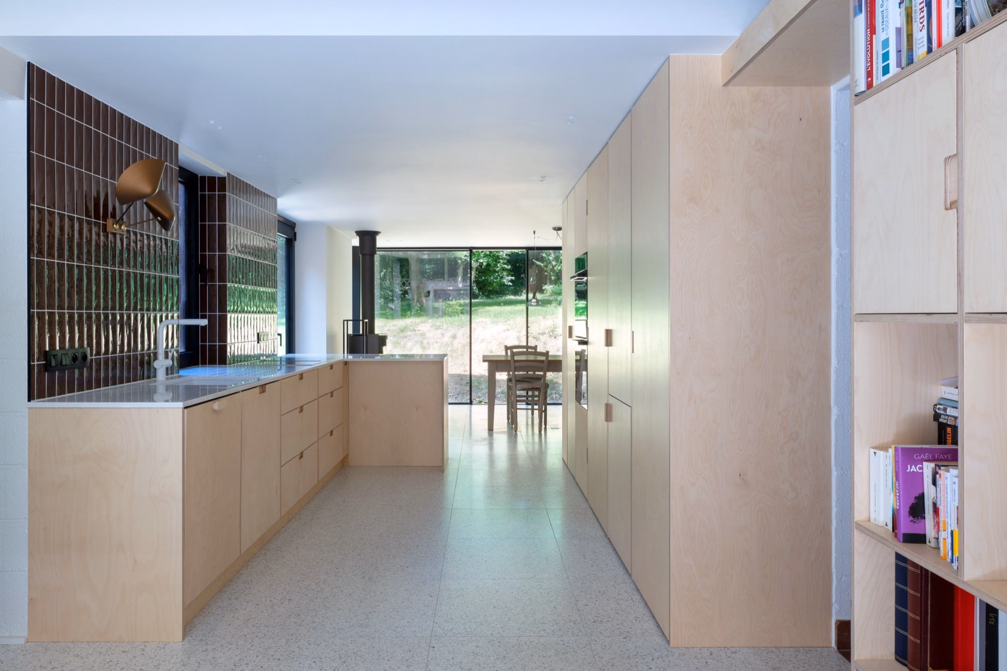A birch-wood kitchen beneath a large window