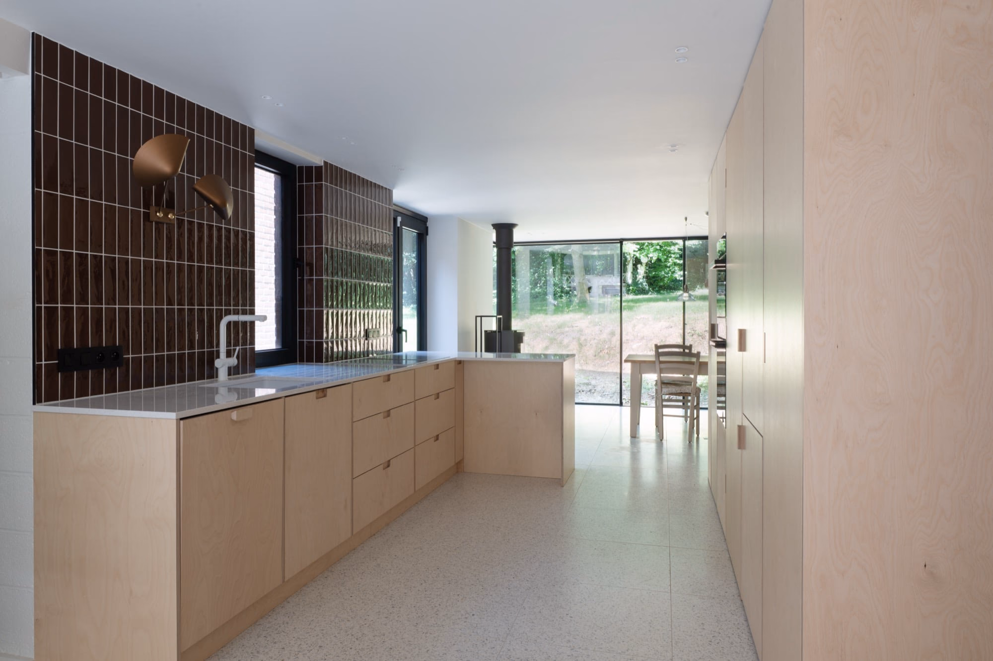 A kitchen with wooden cabinets and granite worktops