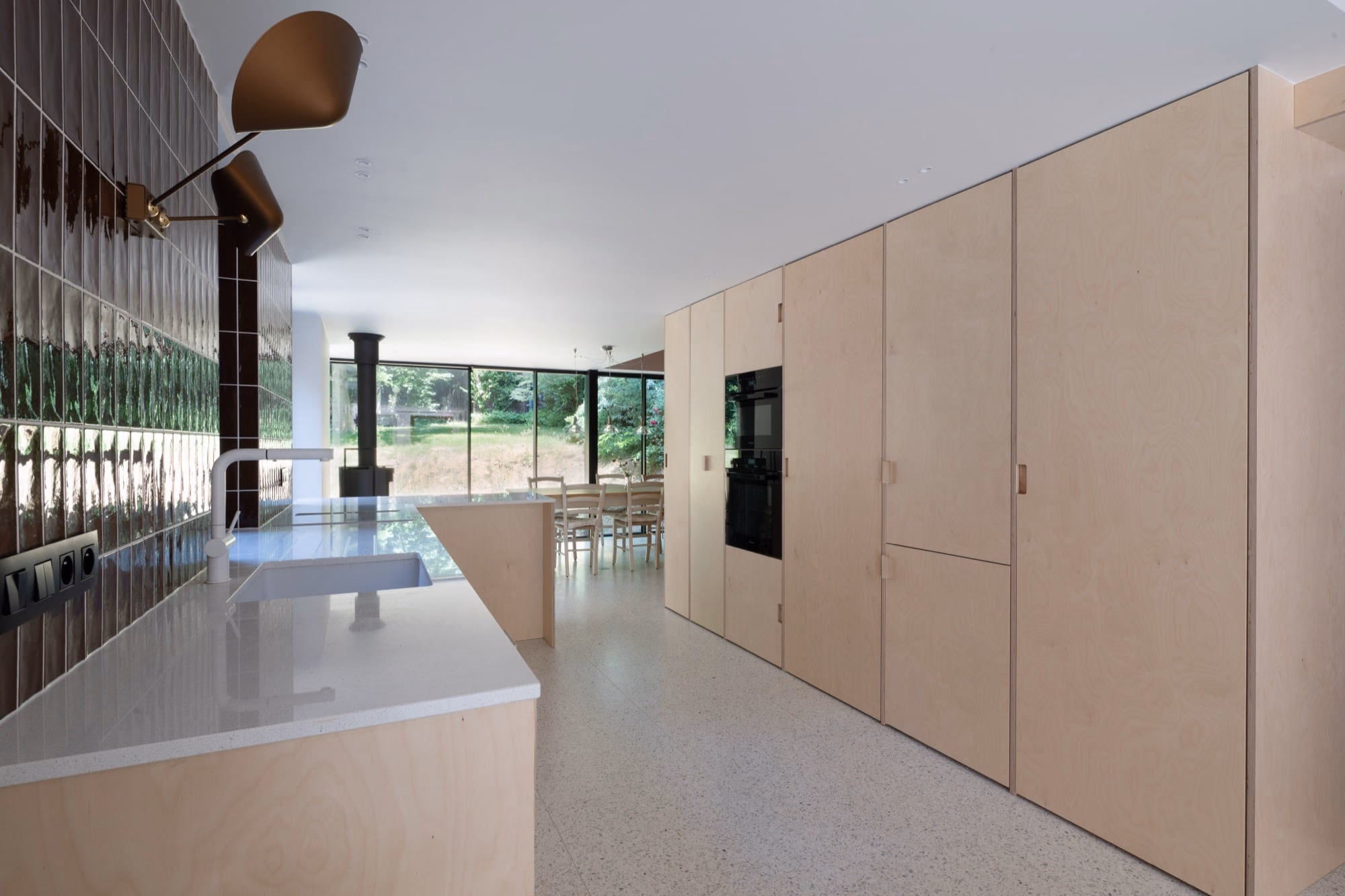 A kitchen with wooden cabinets and white worktops