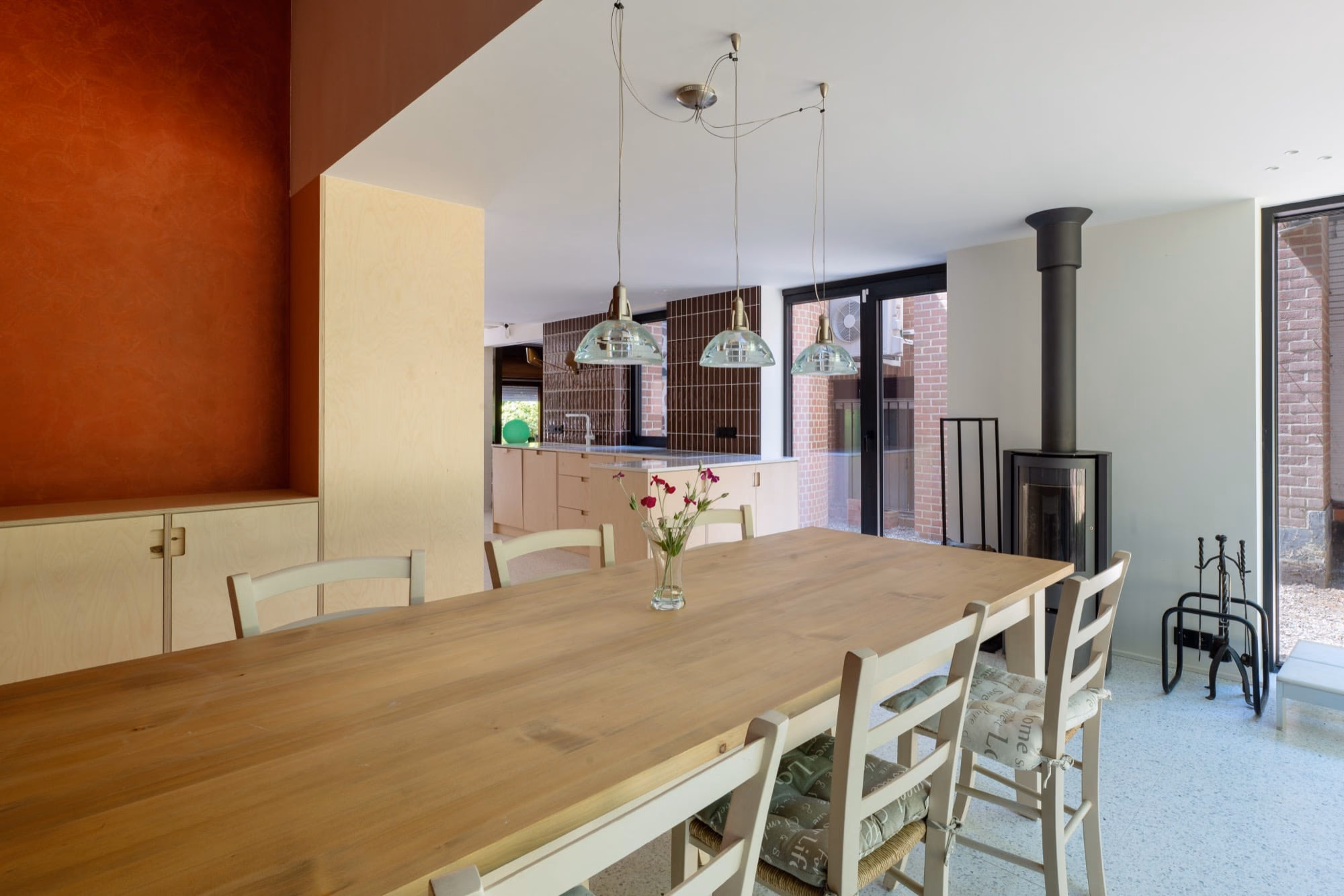 A dining table with a vase of flowers