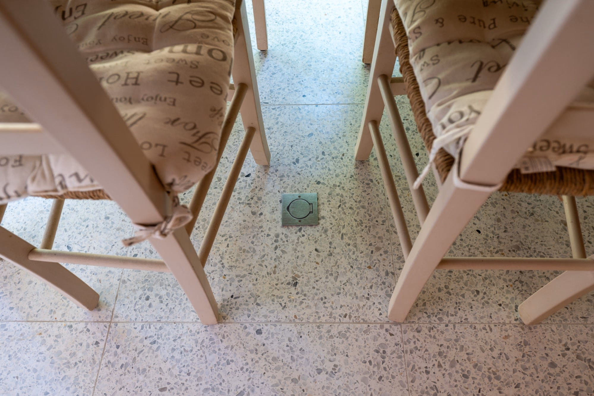 A chair with an embroidered cushion