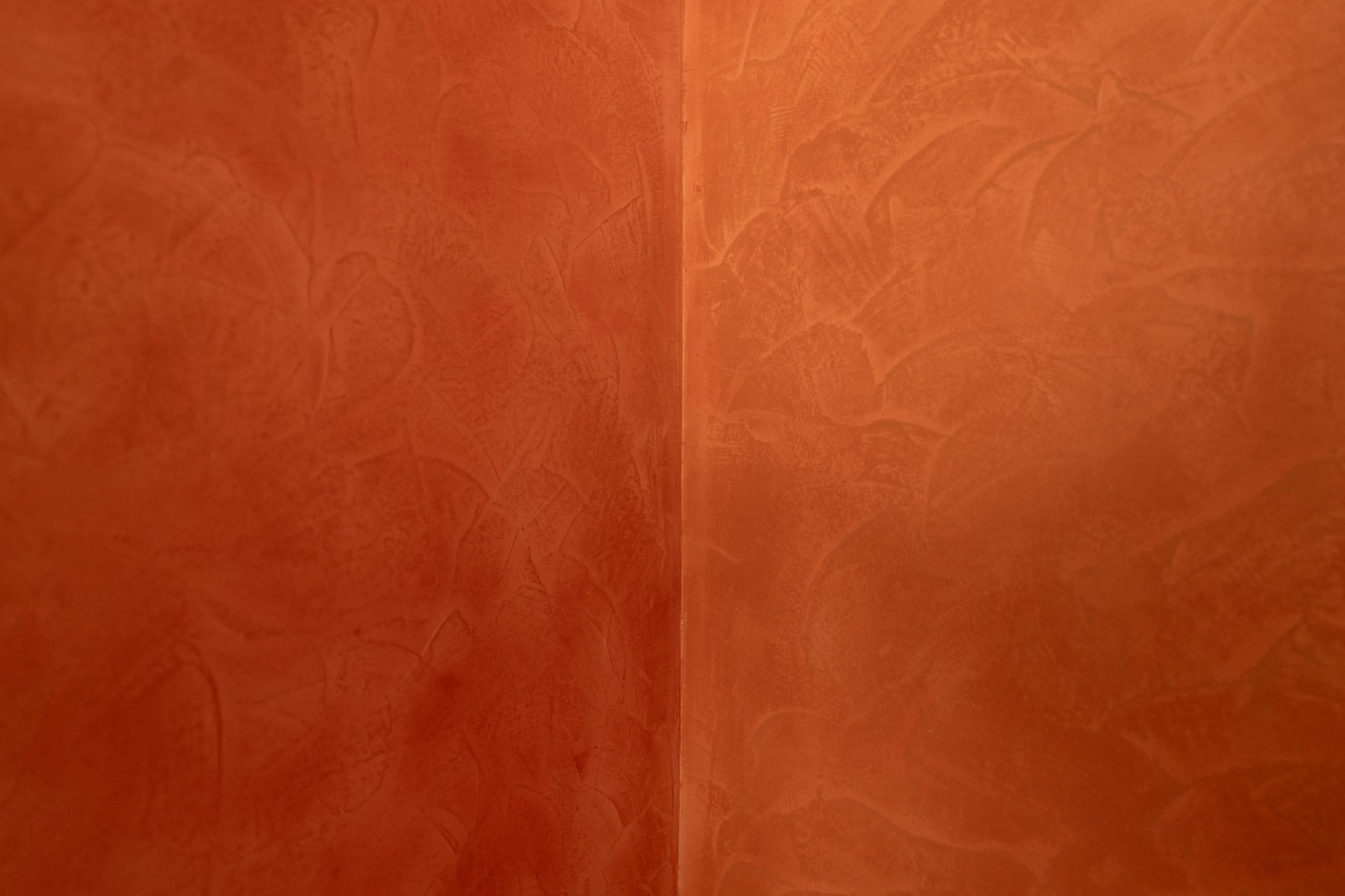 A red wall with a floral pattern