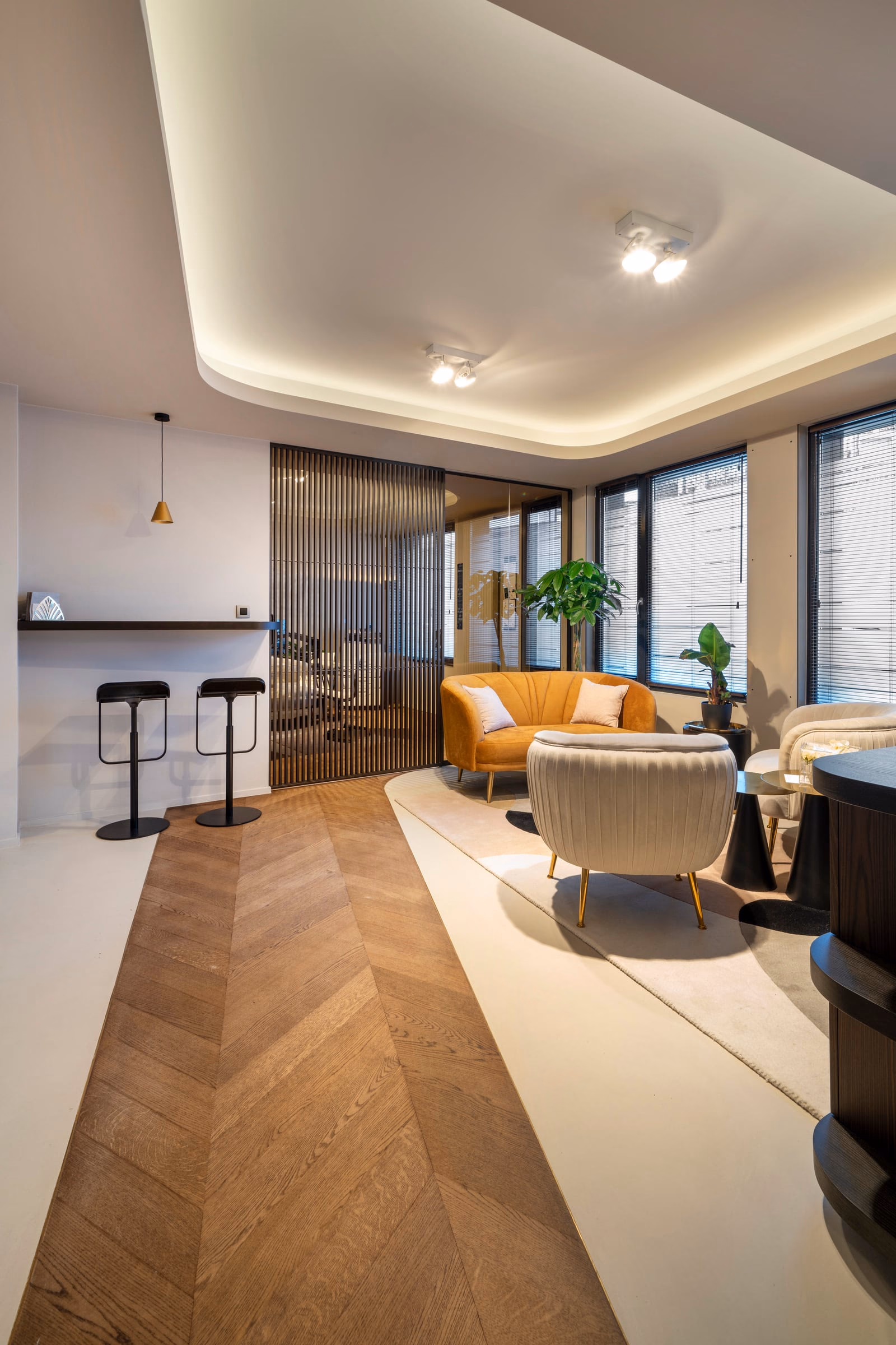 A living room with a sofa and two armchairs